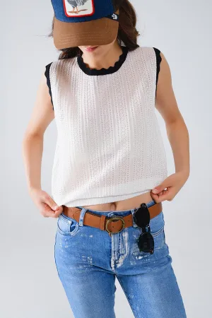 white knitted pointelle top with black wavy trim